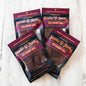 Four bags of Stevie G Hot Honey BBQ beef jerky